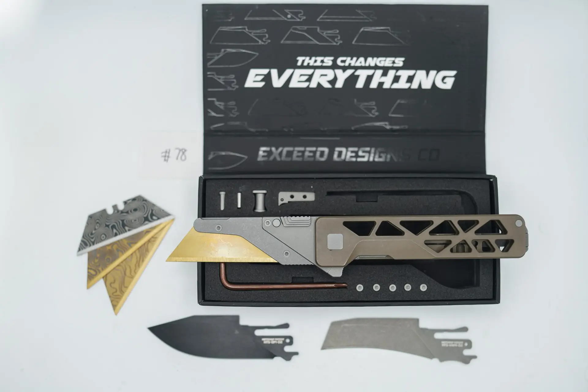 BUILD #78 — Condition 8/10 — TiRant ULTRA Skeleton ‘SKULTRA’ Centurion Bronze W/Blasted Grey Hardware + Original Box W/Spare Grey Blasted Hardware Kit / Lock Bar insert + D2 Hawkbill Hotswap Blade + D2 Jet-Black Drop Point Hotswap Blade + 3X Custom Laser Engraved Razor Blades
