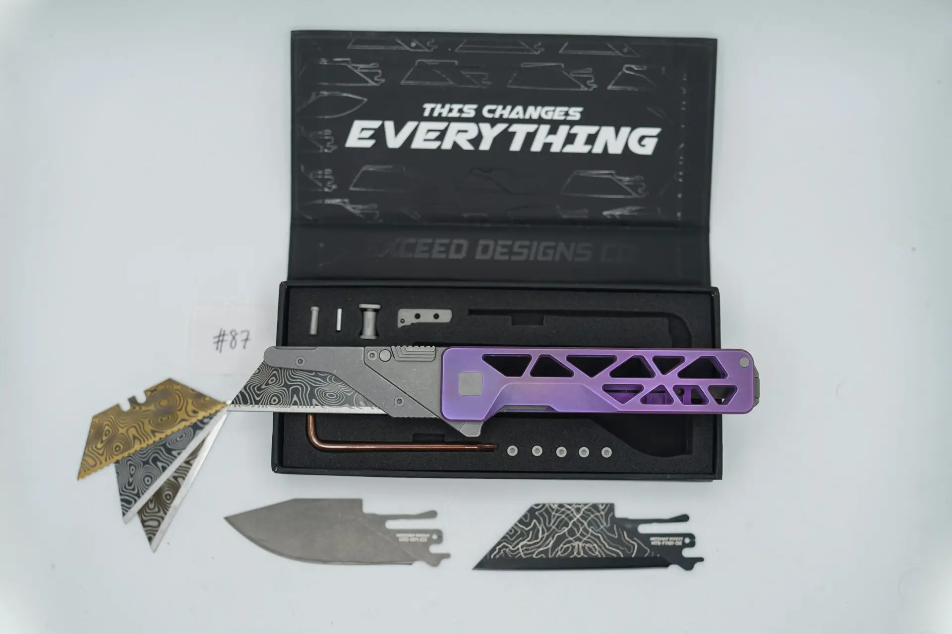 BUILD #87 — Condition 9/10 — TiRant ULTRA Skeleton ‘SKULTRA’ Custom RARE Vibrant Purple Haze W/Blasted Grey Hardware + Original Box W/Spare Grey Blasted Hardware Kit / Lock Bar insert + Blem Laser 1-Sided D2 Full Razor Hotswap Blade + Blem Stonewashed Drop Point Hotswap Blade + 3X Custom Laser Engraved Razor Blades