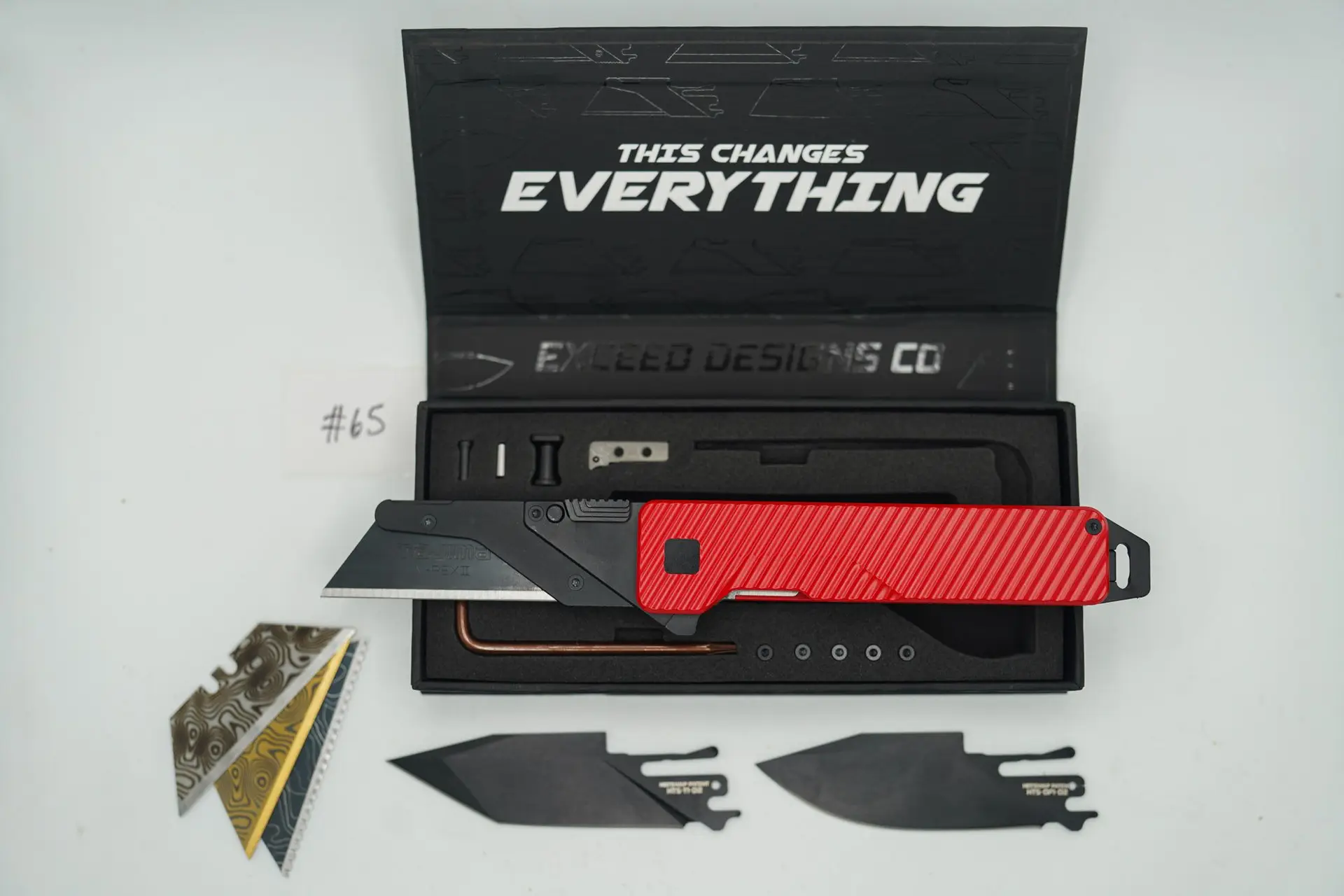 BUILD #65 — Condition 9/10 — TiRant ULTRA Dual Milled SLASH W/Custom Bright Red Cerakote + Installed Full-Length Skeleton Stonewash Pry Bar Backspacer + Original Box W/ Spare Jet-Black PVD Hardware Kit / Lock Bar insert + D2 Jet-Black Tanto Hotswap Blade + D2 Jet-Black Drop Point Hotswap Blade + 3X Custom Laser Engraved Razor Blades