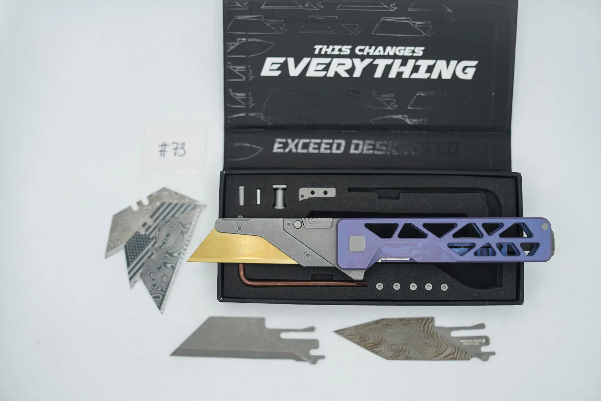 BUILD #73 — Condition 8/10 — TiRant ULTRA Skeleton ‘SKULTRA’ Custom RARE Dark-Purple Haze W/Blasted Grey Hardware + Original Box W/Spare Grey Blasted Hardware Kit / Lock Bar insert + Blem D2 Full Razor Hotswap Blade + Blem Topo Tanto Stonewashed Hotswap Blade + 3X Custom Laser Engraved Razor Blades