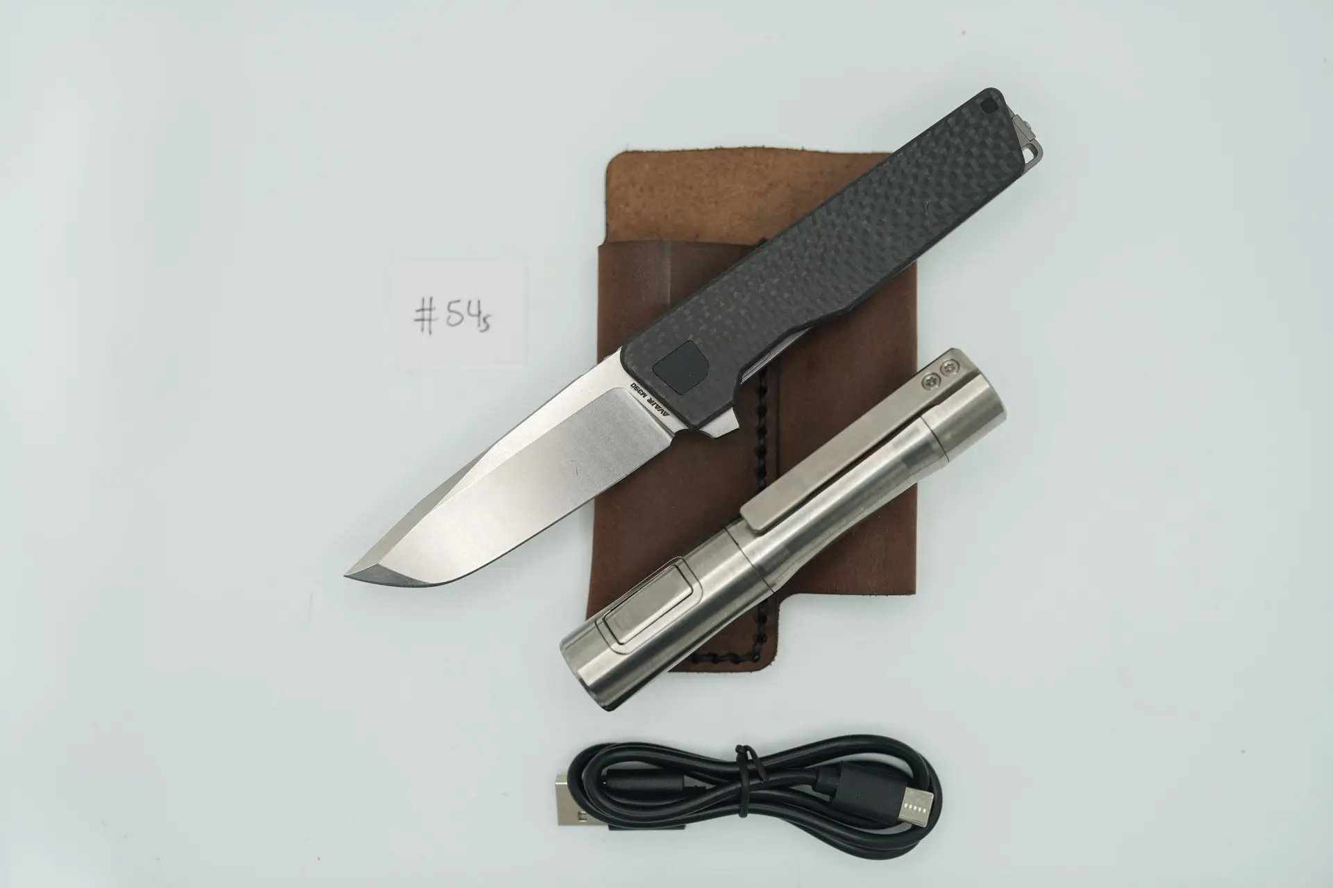 BUILD #54s Combo — Condition 10/10 — AVAIR M390 W/Carbon Fiber Contoured RH Scale (Rare Pre Thousands Serialized “BUILD 999”) + Installed SKIFF Bearings + 10/10 Rampant R4 519a Titanium Flashlight In RAW Machined Finish W/Long Machined Clip + R4 SAPPHIRE GLASS Upgraded Lens + 9/10 Prototype Dark Brown V1 FieldPro Pocket Organizer