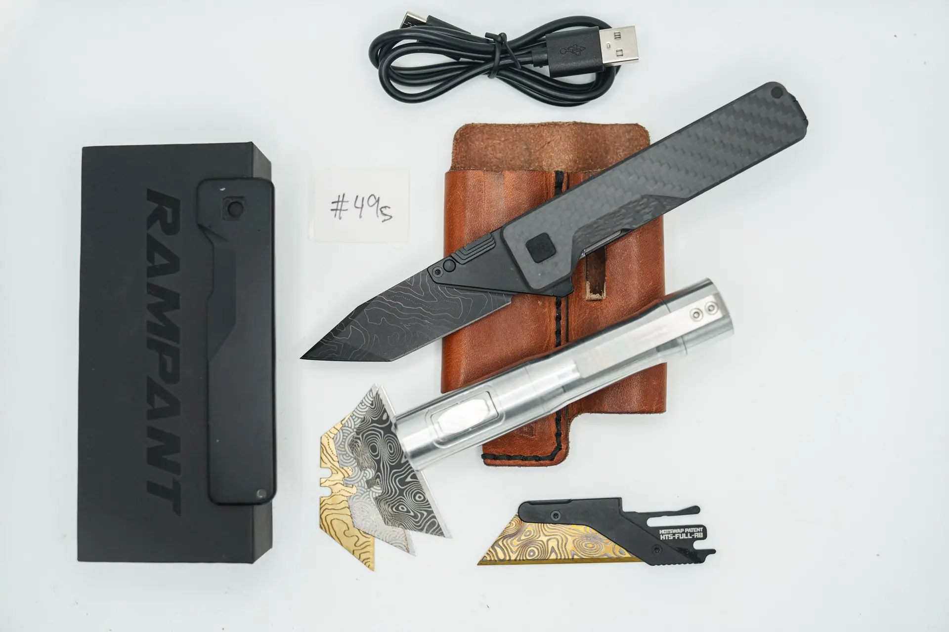 BUILD #49s Combo — Condition 9/10 — TiRant ULTRA 50/50 Smooth Carbon Fiber RH Scale / Jet-Black PVD Titanium LH Scale + Original 7/10 Jet-Black PVD smooth RH Scale + SKIFF Bearings Installed + 8/10 Blem D2 Topo Laser Engraved Tanto Hotswap Blade + 4X Custom Laser Engraved Razor Blades + 10/10 RAW 519a Rampant R4 Aluminum Flashlight + 7/10 Prototype. Brown Leather FieldPro Pocket Organizer