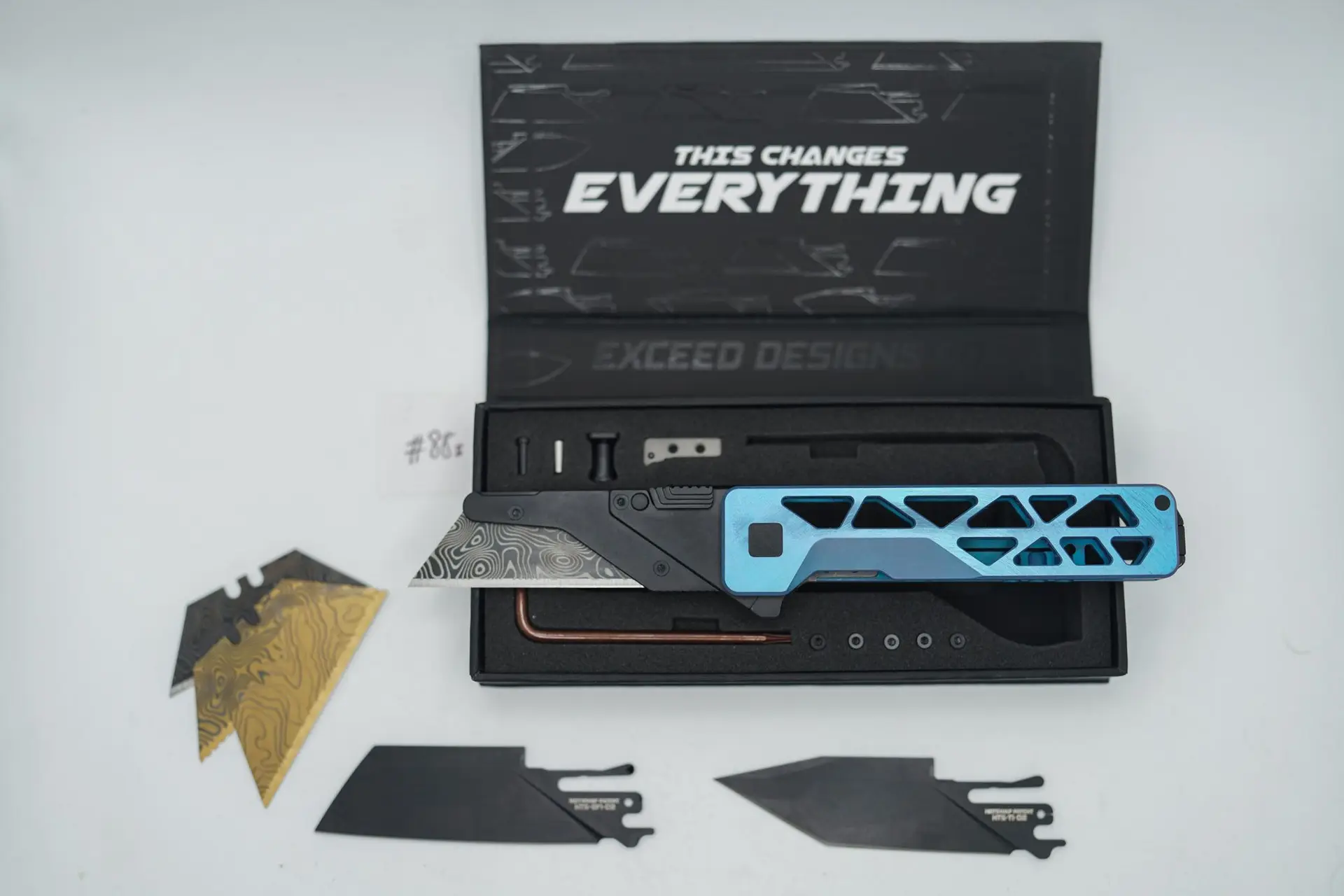 BUILD #88s — Condition 9/10 — TiRant ULTRA Skeleton ‘SKULTRA’ Custom Hand Sanded-Face Prototype + Aqua-BLUE Titanium ANO Applied + SKIFF Bearings Pre-installed + W/Jet-Black PVD Hardware + Original Box W/Jet-Black PVD Hardware Kit / Lock Bar insert + D2 Jet-Black Tanto Hotswap Blade + D2 Jet-Black Sheepsfoot Hotswap Blade + 4X Custom Laser Engraved Razor Blades