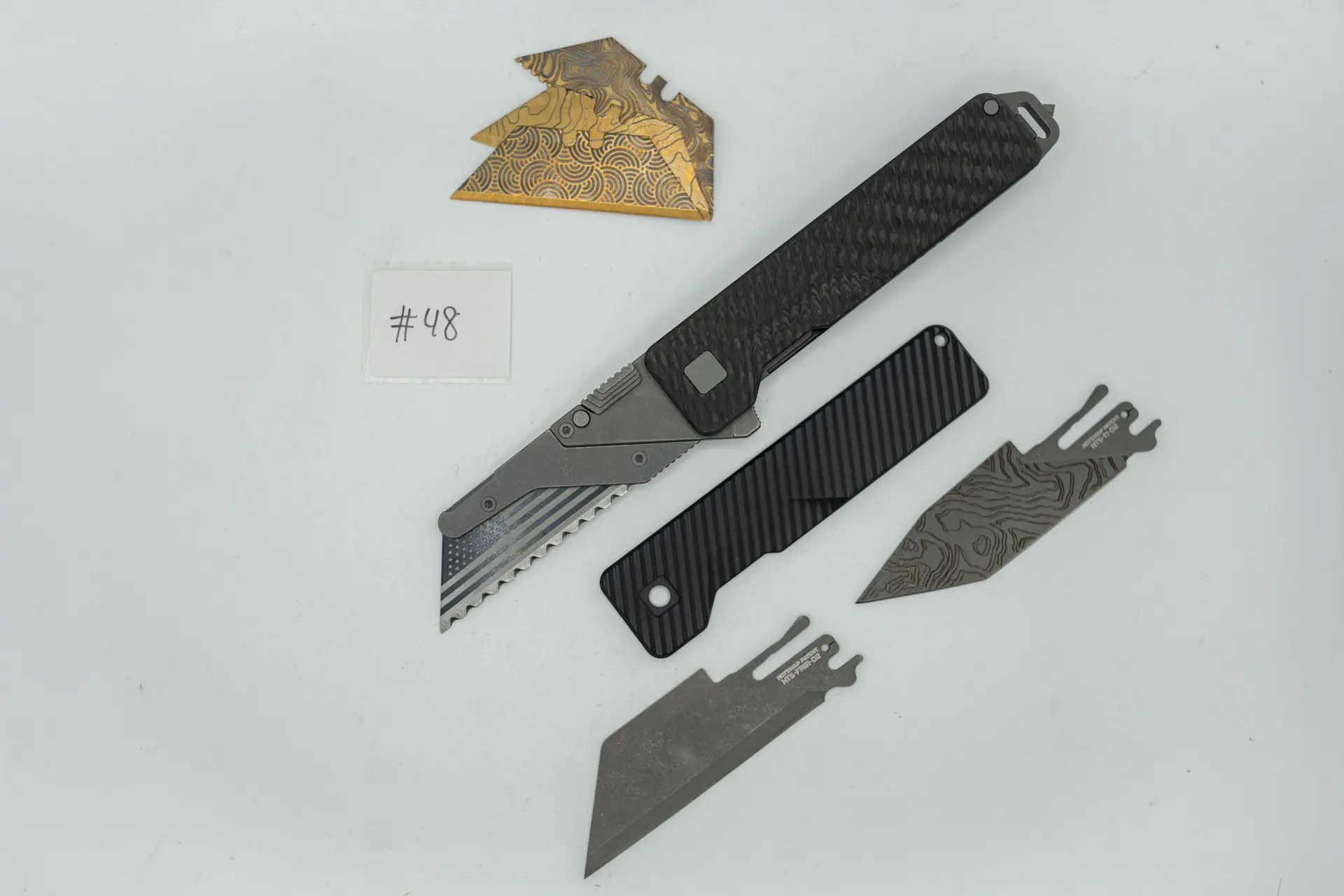 BUILD #48 Combo — Condition 10/10 — TiRant ULTRA Carbon Fiber USA-Milled Deep Slash RH Scale + Jet-Black PVD Deep Slash LH Scale + Original Deep Slash RH Ti Black PVD Scale + Installed Skeleton Glass-Breaker Rear Spacer + 4X Custom Laser Engraved Razor Blades + D2 Full-Razor Style Hotswap Blade + Half Tanto Topo Lasered Blem Blade