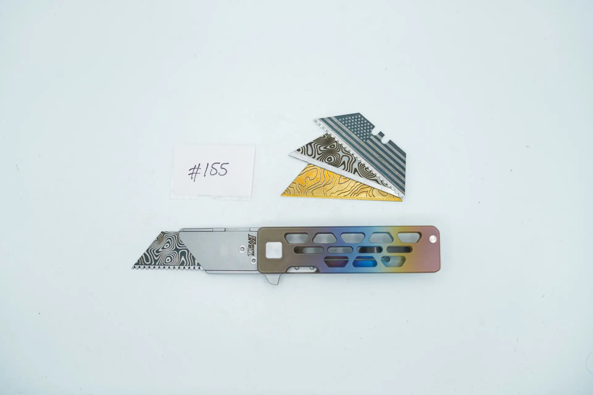 BUILD #155 — Condition 9/10 — TiRant RAZOR V3 Skeleton + Custom Hand-Applied Color Fade ANO + Pre-installed SKIFF Bearings + Rear Flush Backspacer + 38MM Mini Clip + 3X Custom Laser Engraved Razor Blades From The ToolRoom